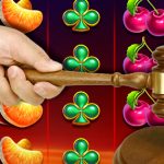 Hand Using a Gavel With a Slots Background