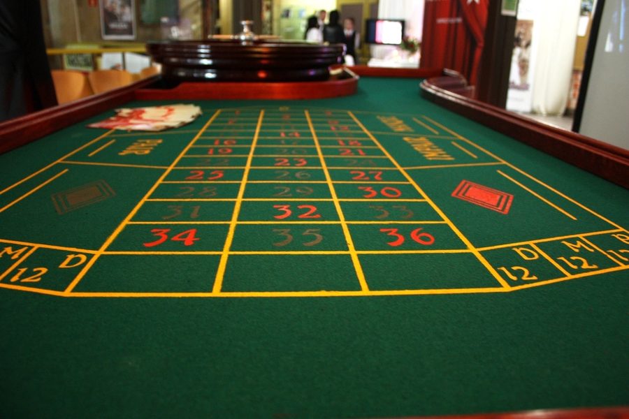 A roulette table with the dealer on station.